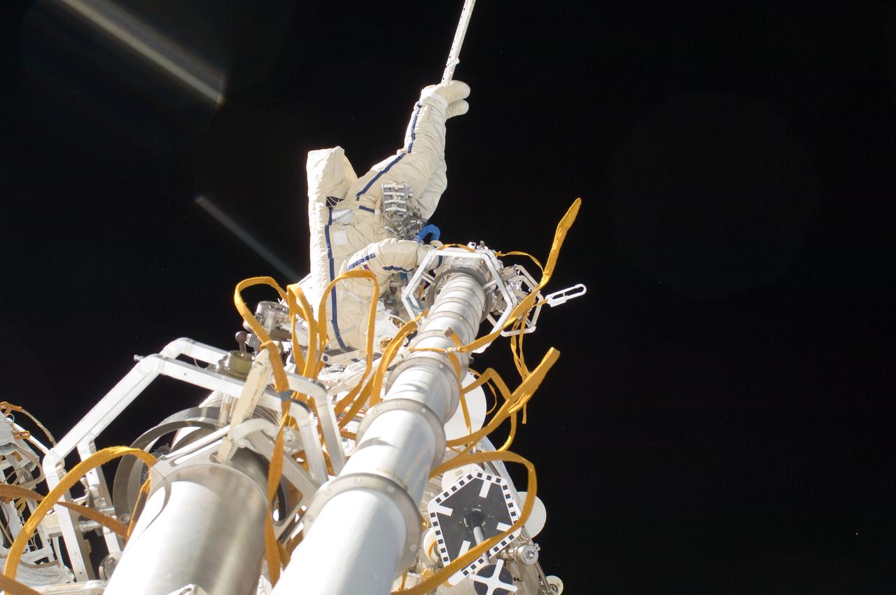 ISS032-E-020856 (20 Aug. 2012) --- Russian cosmonaut Yuri Malenchenko, Expedition 32 flight engineer, participates in a session of extravehicular activity (EVA) to continue outfitting the International Space Station. During the five-hour, 51-minute spacewalk, Malenchenko and Russian cosmonaut Gennady Padalka (out of frame), commander, moved the Strela-2 cargo boom from the Pirs docking compartment to the Zarya module to prepare Pirs for its eventual replacement with a new Russian multipurpose laboratory module. The two spacewalking cosmonauts also installed micrometeoroid debris shields on the exterior of the Zvezda service module and deployed a small science satellite.