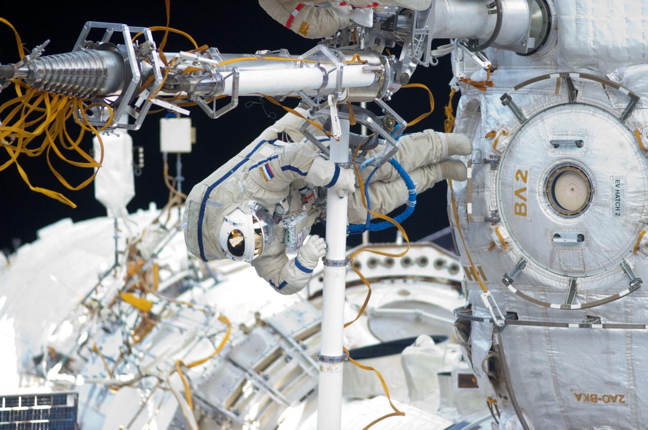 ISS032-E-021058 (20 Aug. 2012) --- Russian cosmonaut Yuri Malenchenko, Expedition 32 flight engineer, participates in a session of extravehicular activity (EVA) to continue outfitting the International Space Station. During the five-hour, 51-minute spacewalk, Malenchenko and Russian cosmonaut Gennady Padalka (out of frame), commander, moved the Strela-2 cargo boom from the Pirs docking compartment to the Zarya module to prepare Pirs for its eventual replacement with a new Russian multipurpose laboratory module. The two spacewalking cosmonauts also installed micrometeoroid debris shields on the exterior of the Zvezda service module and deployed a small science satellite.