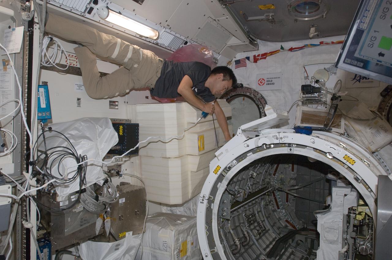 ISS032-E-022196 (21 Aug. 2012) --- Japan Aerospace Exploration Agency astronaut Aki Hoshide, Expedition 32 flight engineer, talks on a microphone while working near the airlock in the Kibo laboratory of the International Space Station. The JEM Robotic Maneuvering System Multi-Purpose Experiment Platform (JEMRMS MPEP) is visible in the airlock.