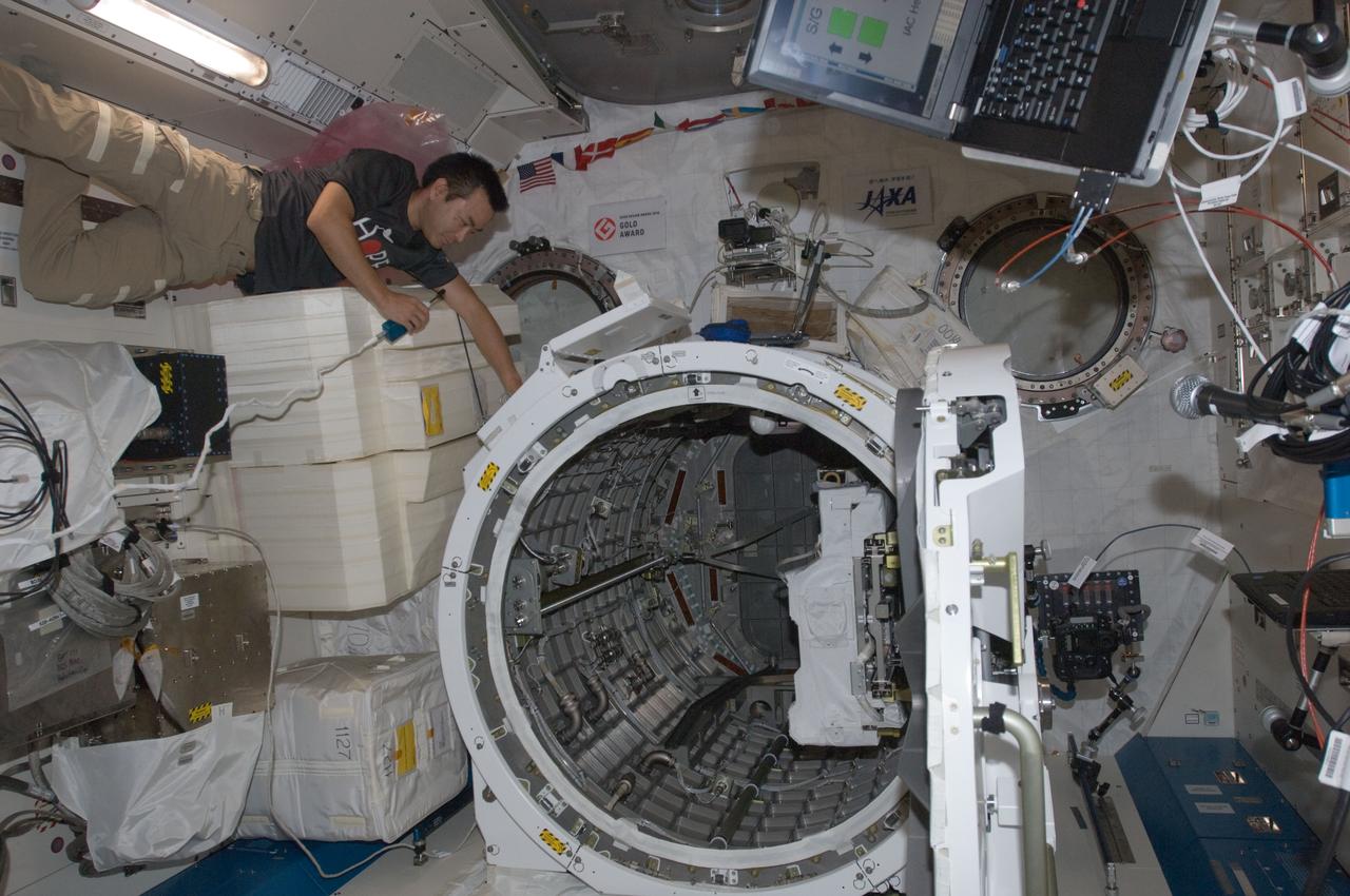 ISS032-E-022200 (21 Aug. 2012) --- Japan Aerospace Exploration Agency astronaut Aki Hoshide, Expedition 32 flight engineer, talks on a microphone while working near the airlock in the Kibo laboratory of the International Space Station. The JEM Robotic Maneuvering System Multi-Purpose Experiment Platform (JEMRMS MPEP) is visible in the airlock.