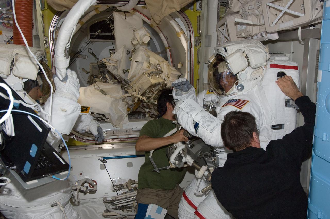 ISS032-E-024618 (30 Aug. 2012) --- NASA astronaut Joe Acaba (center), Russian cosmonaut Yuri Malenchenko (right foreground), Japan Aerospace Exploration Agency astronaut Aki Hoshide (left) and NASA astronaut Sunita Williams, all Expedition 32 flight engineers, prepare for the start of the mission?s second session of extravehicular activity (EVA) in the International Space Station?s Quest airlock. Hoshide and Williams are attired in their Extravehicular Mobility Unit (EMU) spacesuits.