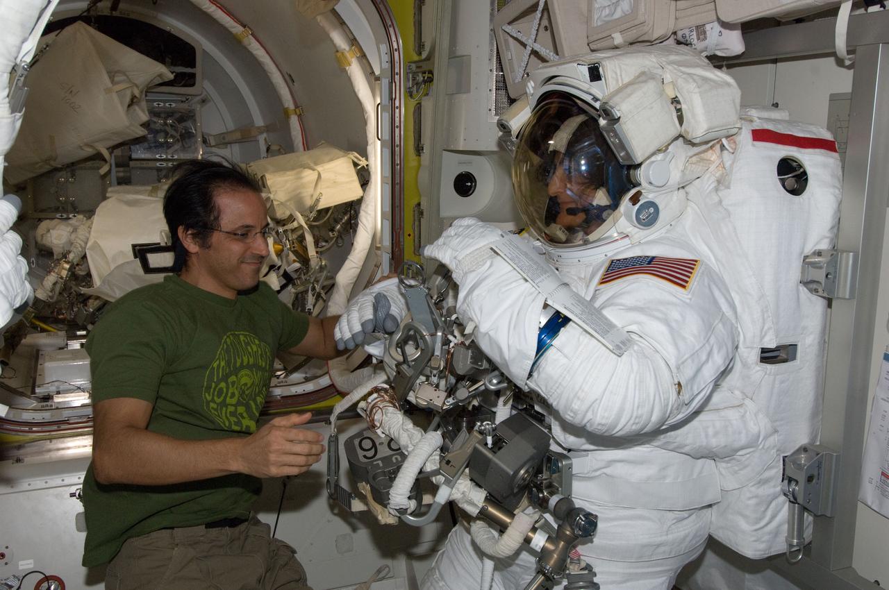ISS032-E-024621 (30 Aug. 2012) --- NASA astronauts Joe Acaba and Sunita Williams, both Expedition 32 flight engineers, prepare for the start of the mission?s second session of extravehicular activity (EVA) in the International Space Station?s Quest airlock. Williams is attired in her Extravehicular Mobility Unit (EMU) spacesuit.