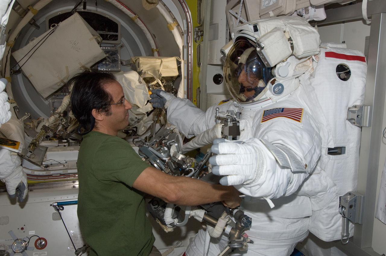 ISS032-E-024624 (30 Aug. 2012) --- NASA astronauts Joe Acaba and Sunita Williams, both Expedition 32 flight engineers, prepare for the start of the mission?s second session of extravehicular activity (EVA) in the International Space Station?s Quest airlock. Williams is attired in her Extravehicular Mobility Unit (EMU) spacesuit.