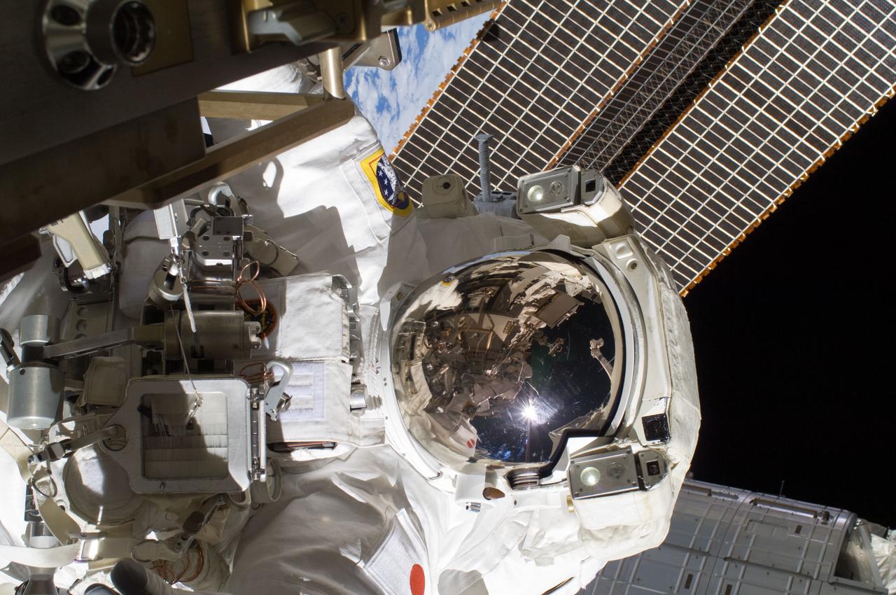 ISS032-E-025163 (5 Sept. 2012) --- Japan Aerospace Exploration Agency astronaut Aki Hoshide, Expedition 32 flight engineer, participates in the mission?s third session of extravehicular activity (EVA). During the six-hour, 28-minute spacewalk, Hoshide and NASA astronaut Sunita Williams (visible in the reflections of Hoshide?s helmet visor), flight engineer, completed the installation of a Main Bus Switching Unit (MBSU) that was hampered last week by a possible misalignment and damaged threads where a bolt must be placed. They also installed a camera on the International Space Station?s robotic arm, Canadarm2.