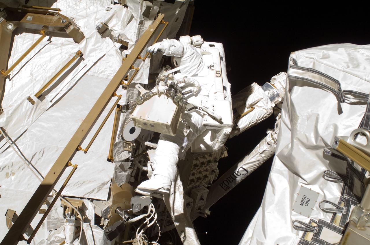 ISS032-E-025217 (5 Sept. 2012) --- Japan Aerospace Exploration Agency astronaut Aki Hoshide, Expedition 32 flight engineer, participates in the mission?s third session of extravehicular activity (EVA). During the six-hour, 28-minute spacewalk, Hoshide and NASA astronaut Sunita Williams (out of frame), flight engineer, completed the installation of a Main Bus Switching Unit (MBSU) that was hampered last week by a possible misalignment and damaged threads where a bolt must be placed. They also installed a camera on the International Space Station?s robotic arm, Canadarm2.