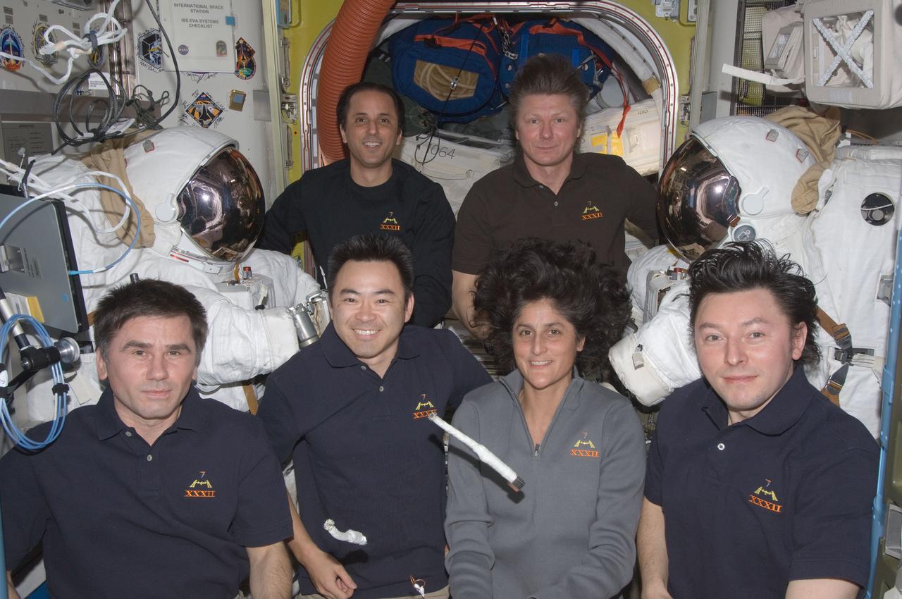 ISS032-E-026396 (11 Sept. 2012) --- Expedition 32 crew members pose for an in-flight crew portrait in the Quest airlock of the International Space Station. Pictured from the left (front row) are Russian cosmonaut Yuri Malenchenko, Japan Aerospace Exploration Agency astronaut Aki Hoshide, NASA astronaut Sunita Williams and Russian cosmonaut Sergei Revin, all flight engineers. Pictured on the back row are Russian cosmonaut Gennady Padalka (right), commander, and NASA astronaut Joe Acaba, flight engineer. A special tool, fashioned onboard for the Sept. 5 spacewalk, floats freely in the foreground.