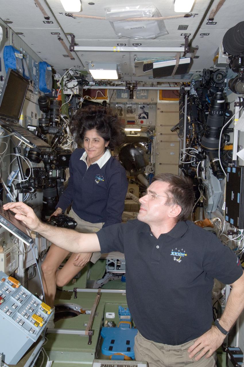 ISS032-E-026854 (15 Sept. 2012) --- NASA astronaut Sunita Williams, Expedition 33 commander; and Russian cosmonaut Yuri Malenchenko, flight engineer, work in the Zvezda Service Module of the International Space Station.