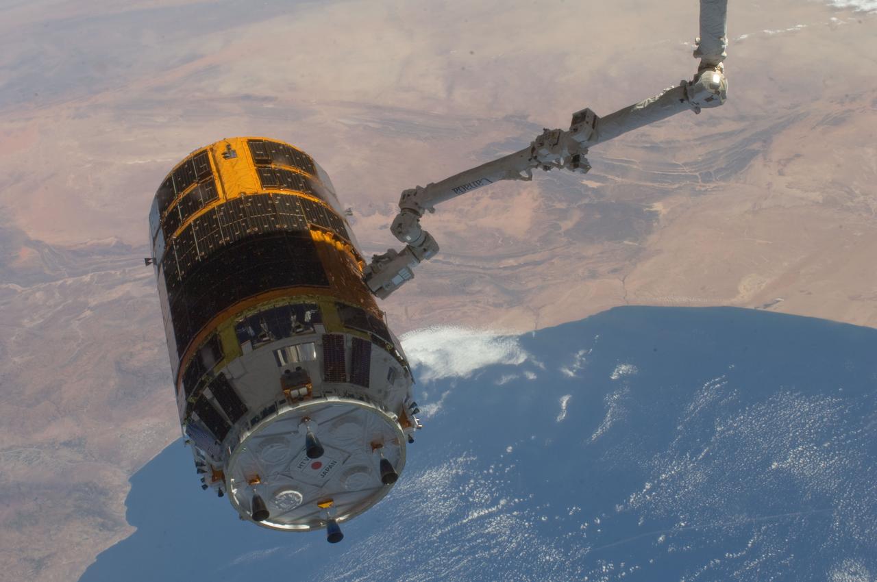 ISS032-E-026884 (12 Sept. 2012) --- With an oblique view of the southwest coast of Morocco serving as a backdrop, the International Space Station's Canadarm2 grasps the unpiloted Japan Aerospace Exploration Agency (JAXA) H-II Transfer Vehicle (HTV-3), filled with trash and unneeded items, in preparation for its release from the station. JAXA astronaut Aki Hoshide and NASA astronaut Joe Acaba, both Expedition 32 flight engineers, used the station's robot arm to grapple the HTV-3 and undock it from the Earth-facing port of the Harmony node. The cargo craft was released at 11:50 a.m. (EDT) on Sept. 12, 2012. Cape Rhir is at lower left and part of the Anti-Atlas mountain range can be seen just inland.