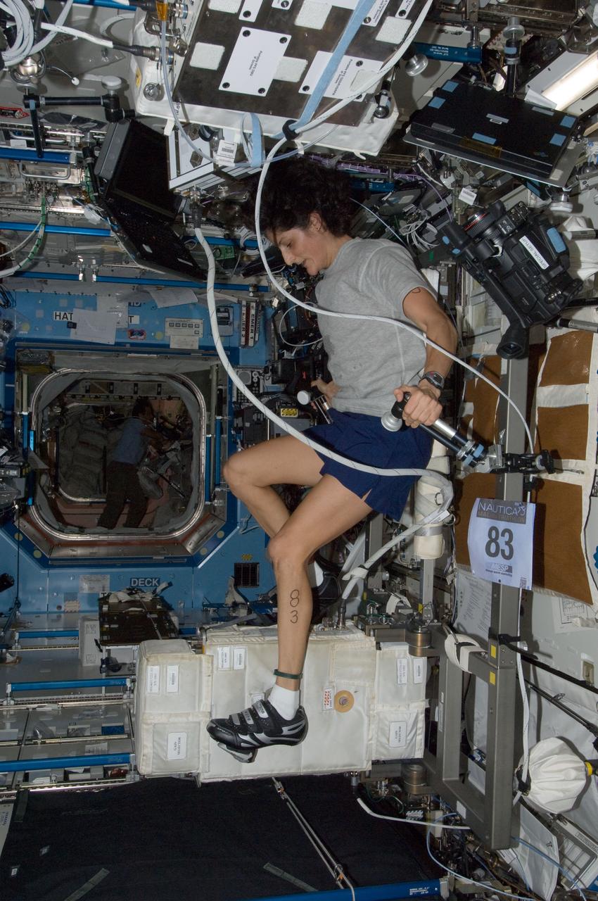 ISS032-E-027050 (16 Sept. 2012) --- NASA astronaut Sunita Williams, Expedition 33 commander, exercises on the Cycle Ergometer with Vibration Isolation System (CEVIS) in the Destiny laboratory of the International Space Station while participating in the first triathlon in space simultaneously with athletes in the Nautica Malibu Triathlon held in Southern California.
