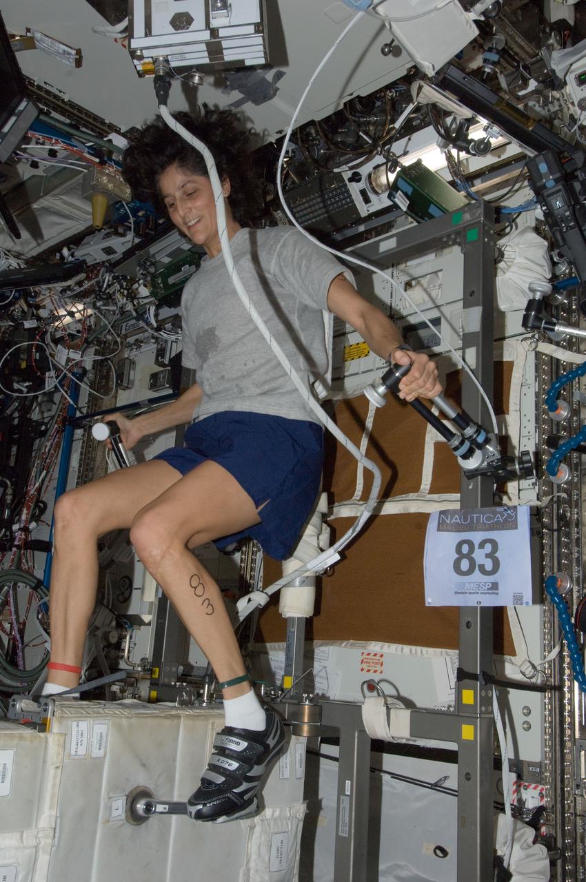 ISS032-E-027051 (16 Sept. 2012) --- NASA astronaut Sunita Williams, Expedition 33 commander, exercises on the Cycle Ergometer with Vibration Isolation System (CEVIS) in the Destiny laboratory of the International Space Station while participating in the first triathlon in space simultaneously with athletes in the Nautica Malibu Triathlon held in Southern California.