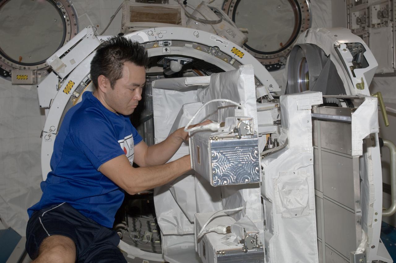 ISS033-E-006446 (21 Sept. 2012) --- In the International Space Station’s Kibo laboratory, Japan Aerospace Exploration Agency astronaut Aki Hoshide, Expedition 33 flight engineer, works with the Small Satellite Orbital Deployer (SSOD) installed on the Multi-Purpose Experiment Platform (MPEP) of the extended slide table of the Kibo airlock.