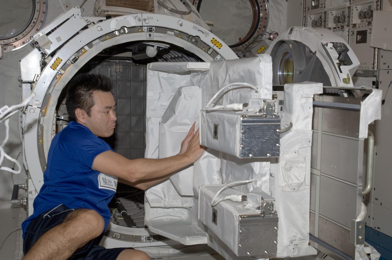 ISS033-E-006447 (21 Sept. 2012) --- In the International Space Station’s Kibo laboratory, Japan Aerospace Exploration Agency astronaut Aki Hoshide, Expedition 33 flight engineer, works with the Small Satellite Orbital Deployer (SSOD) installed on the Multi-Purpose Experiment Platform (MPEP) of the extended slide table of the Kibo airlock.
