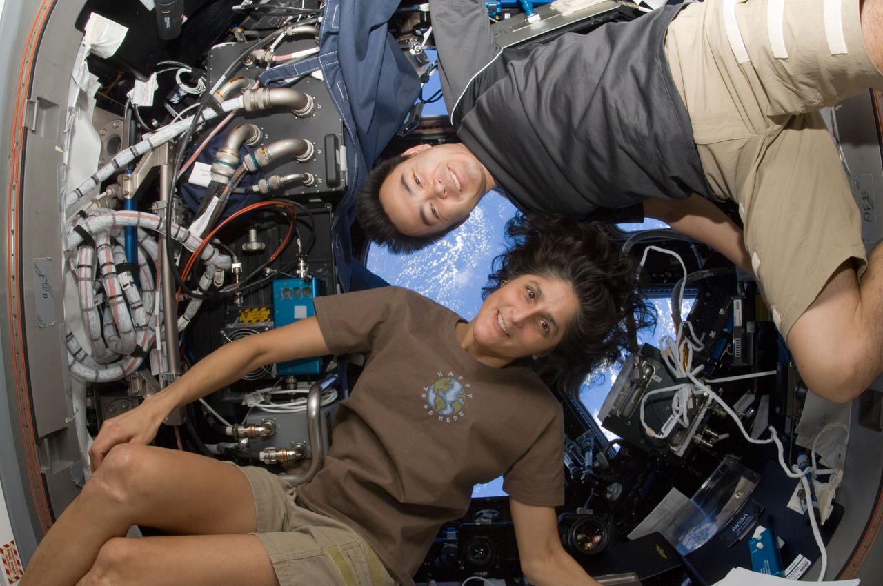 ISS033-E-006757 (23 Sept. 2012) --- NASA astronaut Sunita Williams, Expedition 33 commander; and Japan Aerospace Exploration Agency astronaut Aki Hoshide, flight engineer, pose for a photo in the Cupola of the International Space Station.