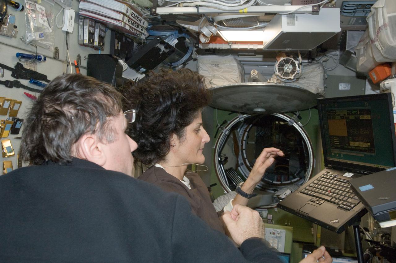 ISS033-E-008091 (28 Sept. 2012) --- In the International Space Station’s Zvezda Service Module, NASA astronaut Sunita Williams, Expedition 33 commander; and Russian cosmonaut Yuri Malenchenko, flight engineer, participate in an onboard training session for the standard Soyuz emergency descent drill, a regular procedure for each station crew.