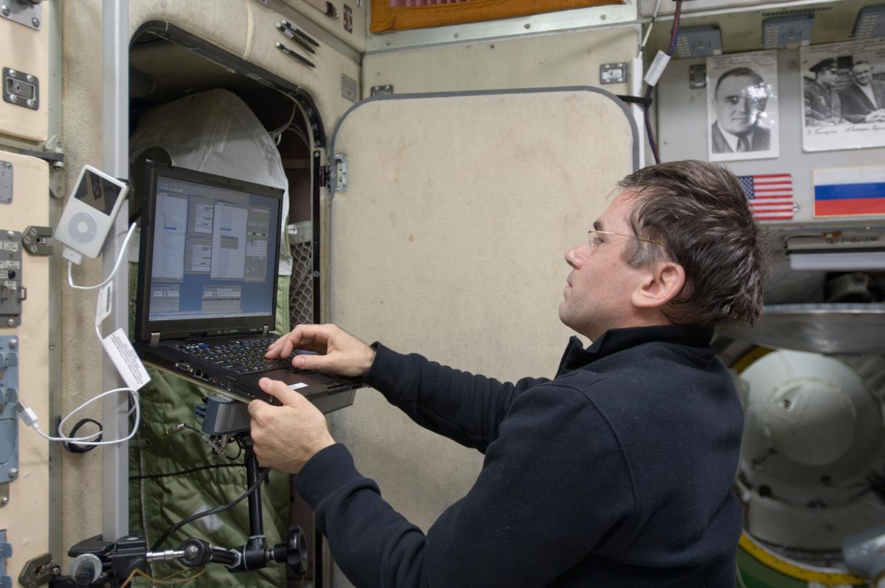 ISS033-E-008108 (28 Sept. 2012) --- In the International Space Station’s Zvezda Service Module, Russian cosmonaut Yuri Malenchenko, Expedition 33 flight engineer, uses a computer during an onboard training session for the standard Soyuz emergency descent drill, a regular procedure for each station crew.