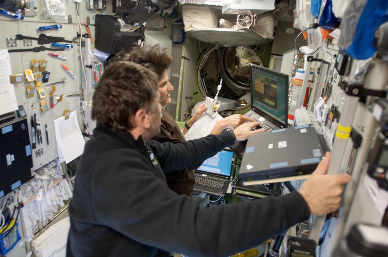 ISS033-E-008111 (28 Sept. 2012) --- In the International Space Station’s Zvezda Service Module, NASA astronaut Sunita Williams, Expedition 33 commander; and Russian cosmonaut Yuri Malenchenko, flight engineer, participate in an onboard training session for the standard Soyuz emergency descent drill, a regular procedure for each station crew.