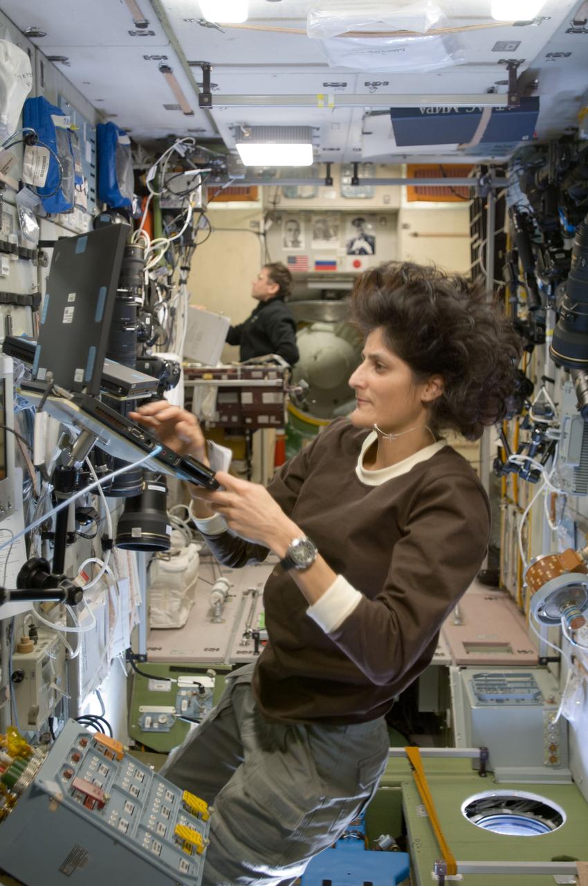 ISS033-E-008132 (28 Sept. 2012) --- In the International Space Station’s Zvezda Service Module, NASA astronaut Sunita Williams, Expedition 33 commander; and Russian cosmonaut Yuri Malenchenko, flight engineer, participate in an onboard training session for the standard Soyuz emergency descent drill, a regular procedure for each station crew.