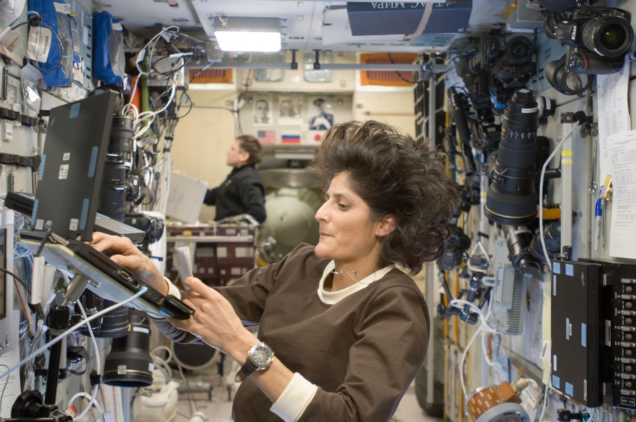 ISS033-E-008135 (28 Sept. 2012) --- In the International Space Station’s Zvezda Service Module, NASA astronaut Sunita Williams, Expedition 33 commander; and Russian cosmonaut Yuri Malenchenko, flight engineer, participate in an onboard training session for the standard Soyuz emergency descent drill, a regular procedure for each station crew.