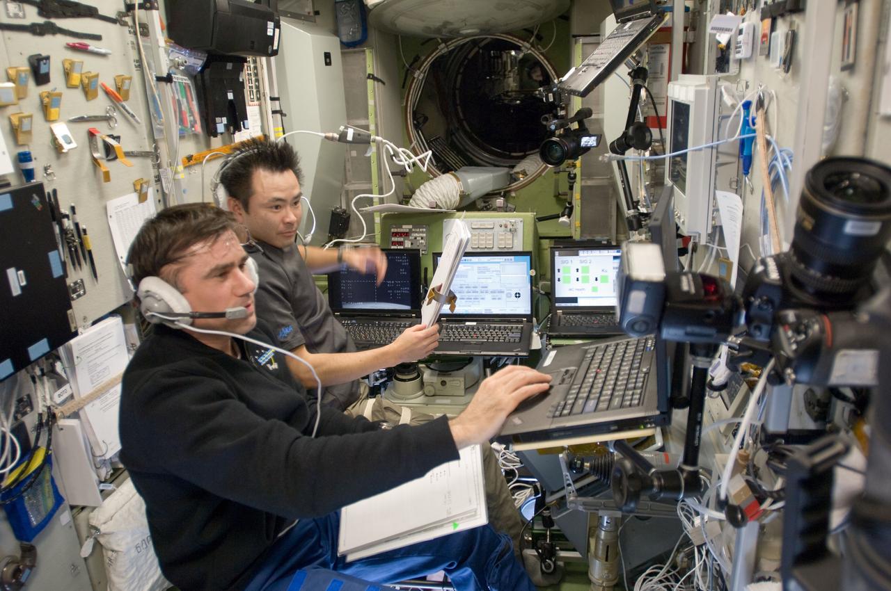ISS033-E-008169 (28 Sept. 2012) --- In the Zvezda Service Module, Russian cosmonaut Yuri Malenchenko (foreground) and Japan Aerospace Exploration Agency astronaut Aki Hoshide, both Expedition 33 flight engineers, monitor the undocking of the European Space Agency's "Edoardo Amaldi" Automated Transfer Vehicle-3 (ATV-3) from the International Space Station.