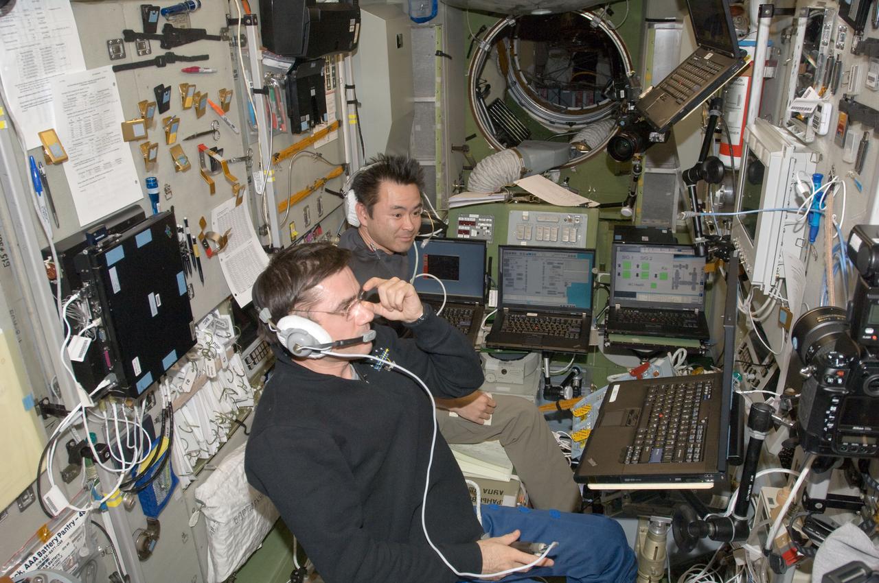 ISS033-E-008176 (28 Sept. 2012) --- In the Zvezda Service Module, Russian cosmonaut Yuri Malenchenko (foreground) and Japan Aerospace Exploration Agency astronaut Aki Hoshide, both Expedition 33 flight engineers, monitor the undocking of the European Space Agency's "Edoardo Amaldi" Automated Transfer Vehicle-3 (ATV-3) from the International Space Station.