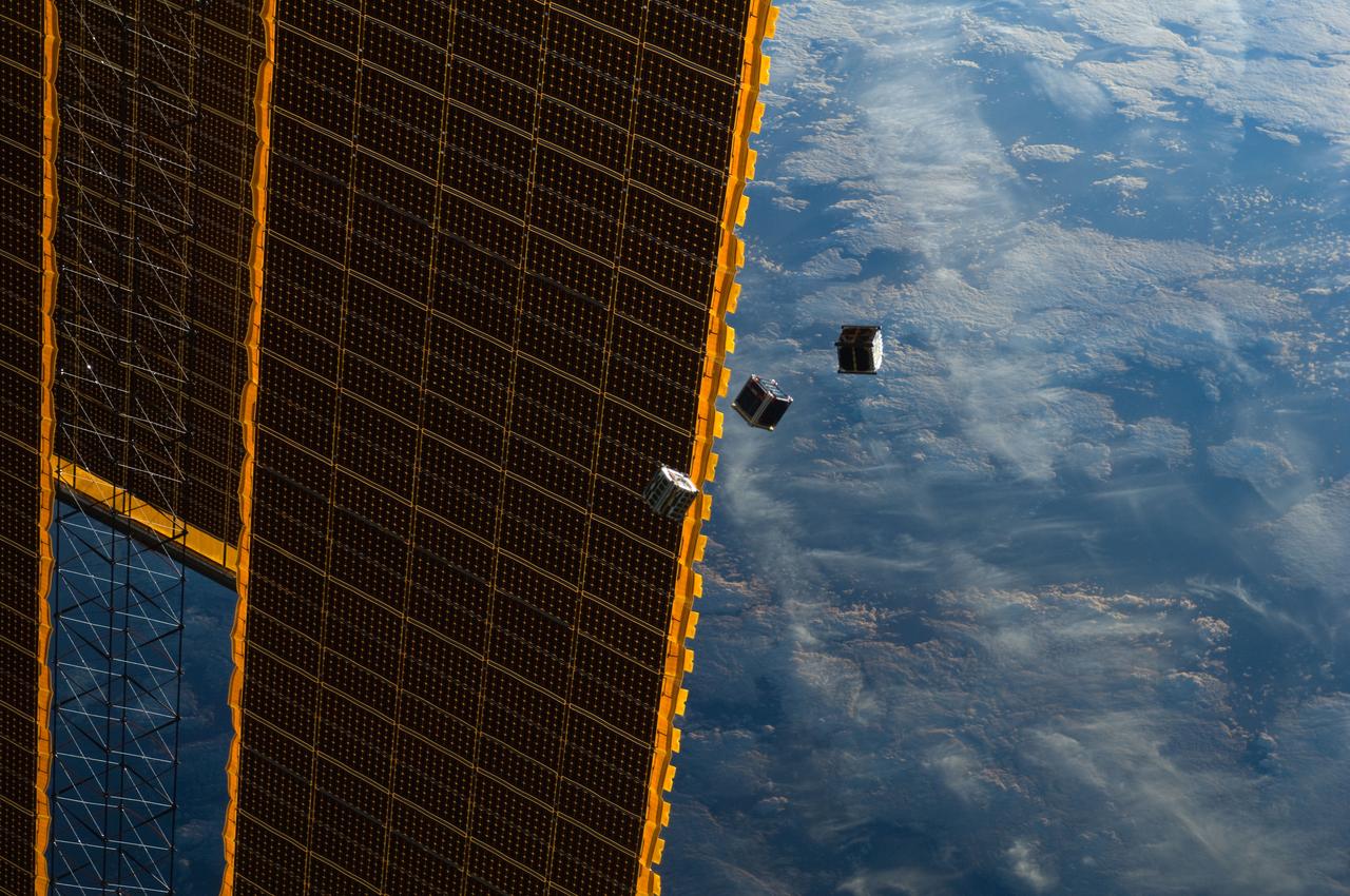 ISS033-E-009285 (4 Oct. 2012) --- Several tiny satellites are featured in this image photographed by an Expedition 33 crew member on the International Space Station. The satellites were released outside the Kibo laboratory using a Small Satellite Orbital Deployer attached to the Japanese module’s robotic arm on Oct. 4, 2012. Japan Aerospace Exploration Agency astronaut Aki Hoshide, flight engineer, set up the satellite deployment gear inside the lab and placed it in the Kibo airlock. The Japanese robotic arm then grappled the deployment system and its satellites from the airlock for deployment. A portion of the station’s solar array panels and a blue and white part of Earth provide the backdrop for the scene.