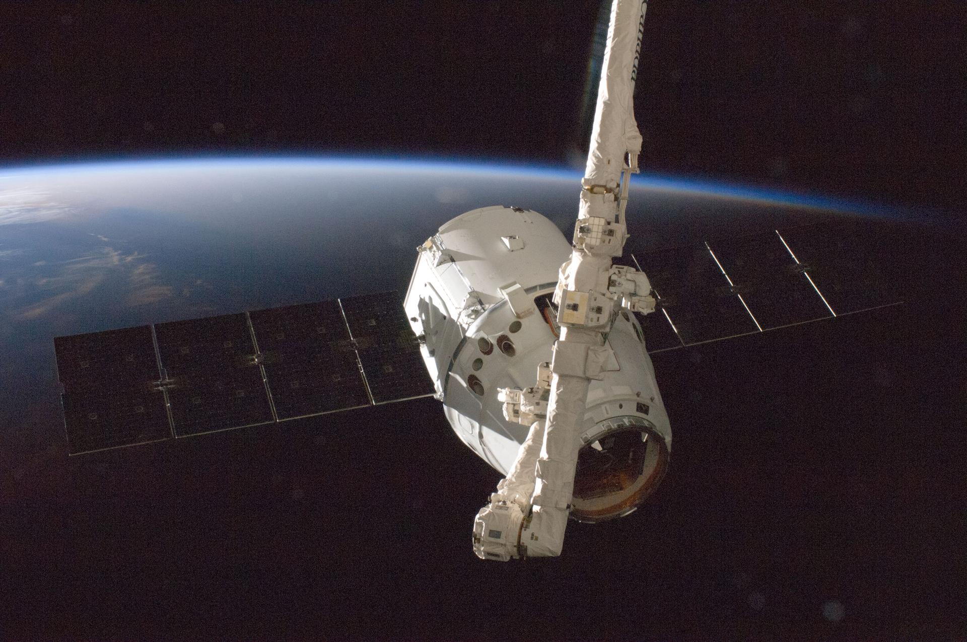 The SpaceX Dragon commercial cargo craft is grappled by the International Space Station’s Canadarm2 robotic arm. Working from the robotics workstation inside the seven-windowed Cupola, Japan Aerospace Exploration Agency astronaut Aki Hoshide, Expedition 33 flight engineer, with the assistance of NASA astronaut Sunita Williams, commander, captured Dragon at 6:56 a.m. (EDT) and used the robotic arm to berth Dragon to the Earth-facing port of the Harmony node Oct. 10, 2012. Dragon is scheduled to spend 18 days attached to the station. During that time, the crew will unload 882 pounds of crew supplies, science research and hardware from the cargo craft and reload it with 1,673 pounds of cargo for return to Earth. After Dragon’s mission at the station is completed, the crew will use Canadarm2 to detach Dragon from Harmony and release it for a splashdown about six hours later in the Pacific Ocean, 250 miles off the coast of southern California. Dragon launched atop a Falcon 9 rocket at 8:35 p.m. Oct. 7 from Cape Canaveral Air Force Station in Florida, beginning NASA's first contracted cargo delivery flight, designated SpaceX CRS-1, to the station.