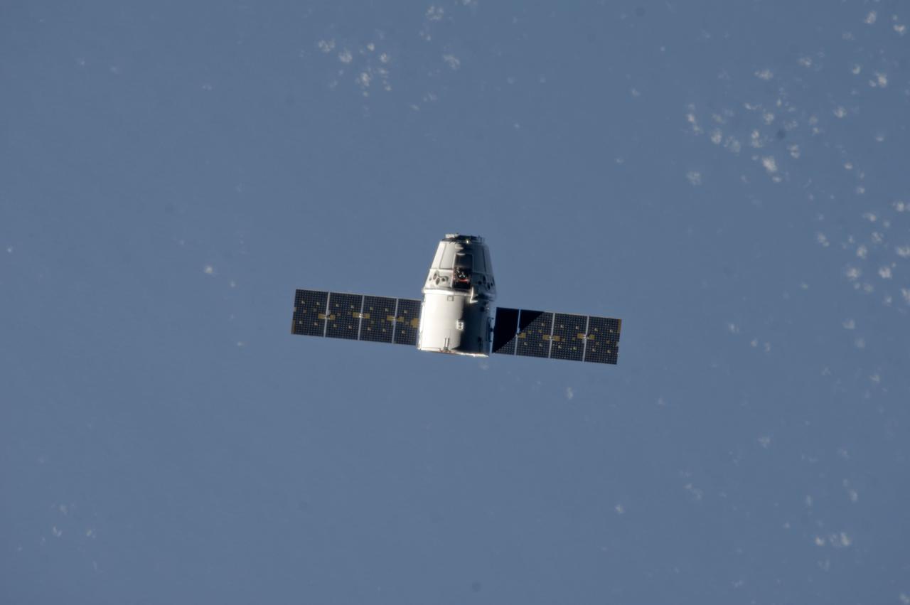 ISS033-E-011355 (10 Oct. 2012) --- The SpaceX Dragon commercial cargo craft makes its relative approach to the International Space Station prior to grapple by the station?s Canadarm2 robotic arm, controlled by Expedition 33 crew members.