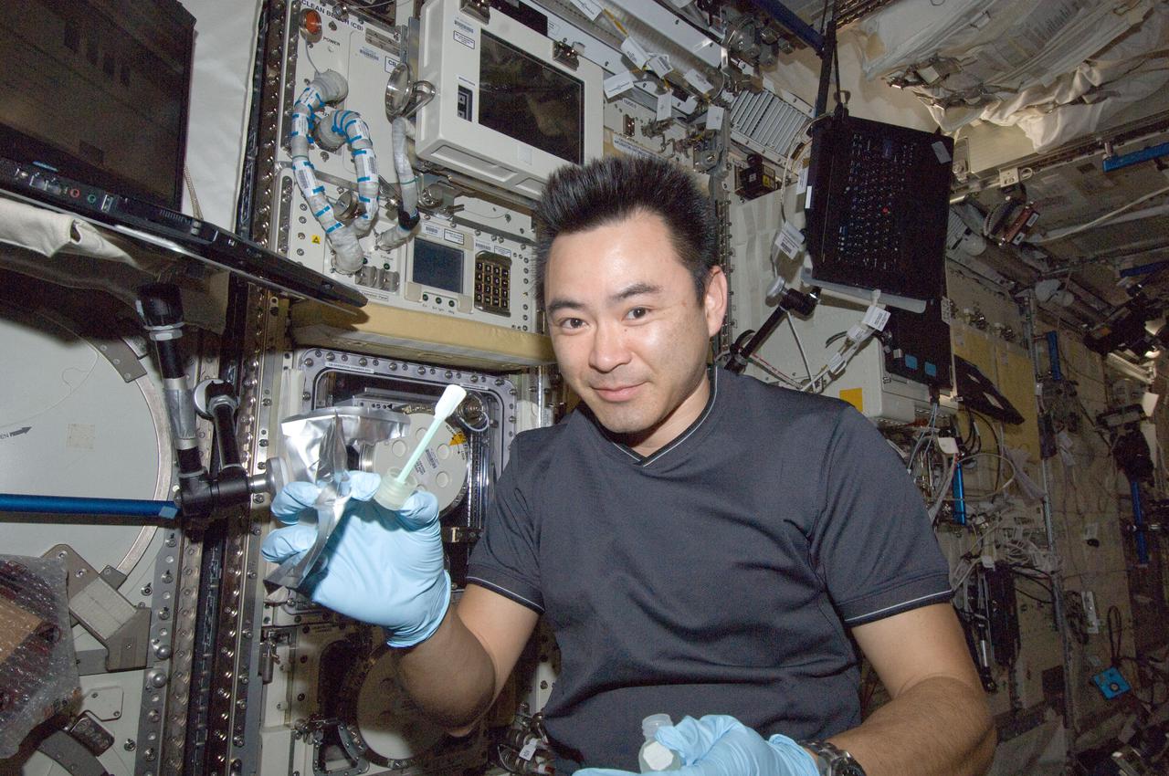 Japan Aerospace Exploration Agency (JAXA) astronaut Akihiko Hoshide,Expedition 33 flight engineer,is photographed performing microbial White Tube sampling in the JPM (JEM Pressurized Module) with wet wipes and sampling sheets for the JAXA MICB (MICROBE-3) experiment.