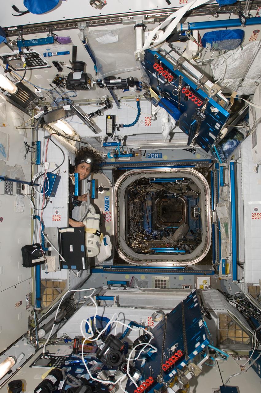 ISS033-E-012794 (18 Oct. 2012) --- NASA astronaut Sunita Williams, Expedition 33 commander, uses a vacuum cleaner during housekeeping operations in the Harmony node of the International Space Station.