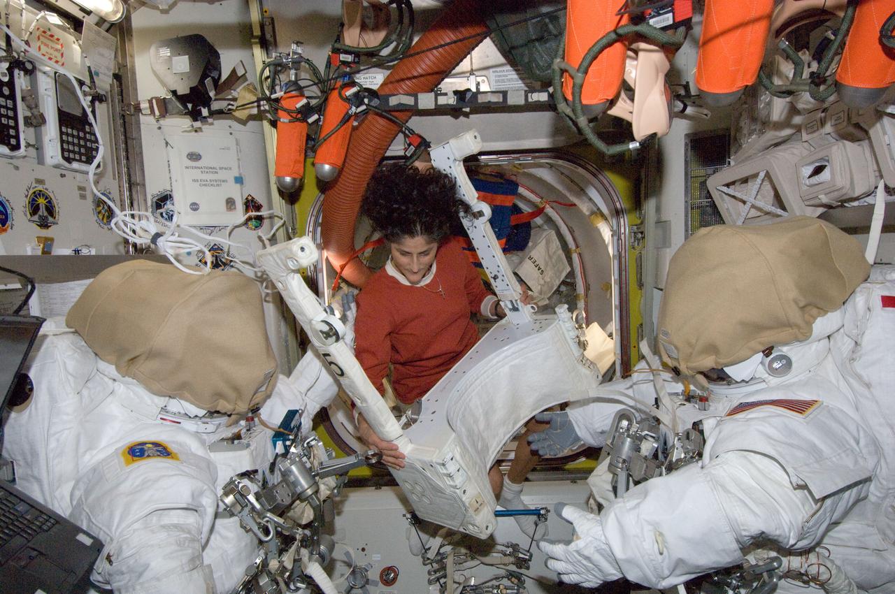 ISS033-E-013412 (21 Oct. 2012) --- NASA astronaut Sunita Williams, Expedition 33 commander, works with Extravehicular Mobility Unit (EMU) spacesuit hardware in the Quest airlock of the International Space Station.