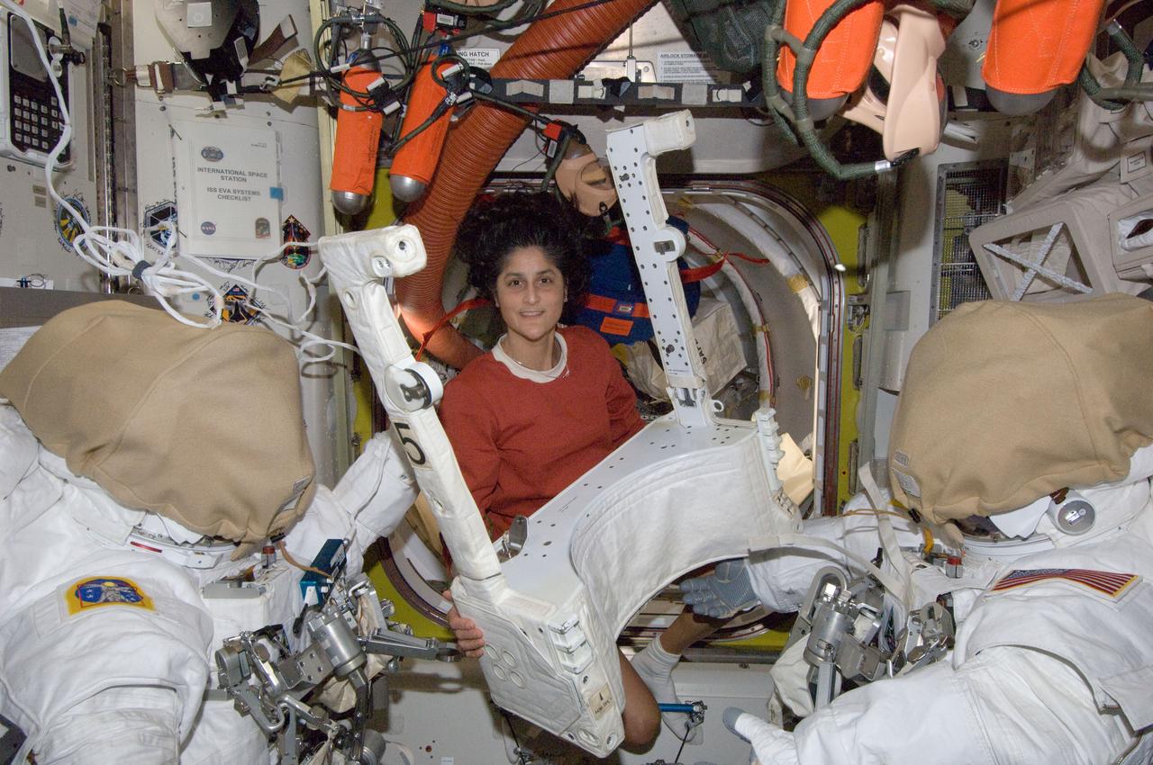 ISS033-E-013413 (21 Oct. 2012) --- NASA astronaut Sunita Williams, Expedition 33 commander, works with Extravehicular Mobility Unit (EMU) spacesuit hardware in the Quest airlock of the International Space Station.