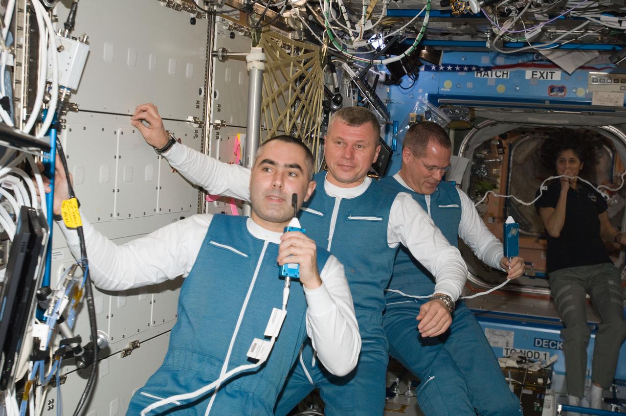 ISS033-E-016110 (25 Oct. 2012) --- Russian cosmonauts Evgeny Tarelkin (left) and Oleg Novitskiy (center); along with NASA astronaut Kevin Ford, all Expedition 33 flight engineers, are pictured in the Destiny laboratory of the International Space Station shortly after docking with the space station in their Soyuz TMA-06M spacecraft.
