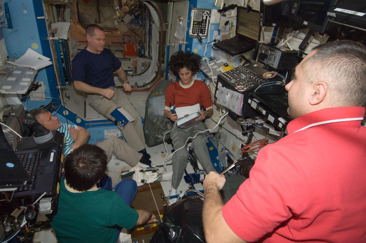 ISS033-E-016177 (25 Oct. 2012) --- Expedition 33 crew members are pictured in the Destiny laboratory of the International Space Station. Pictured clockwise (from top right) are NASA astronaut Sunita Williams, commander; Russian cosmonauts Evgeny Tarelkin, Yuri Malenchenko and Oleg Novitskiy; along with NASA astronaut Kevin Ford, all flight engineers. This photo was taken shortly after Ford, Novitskiy and Tarelkin docked with the space station in their Soyuz TMA-06M spacecraft.