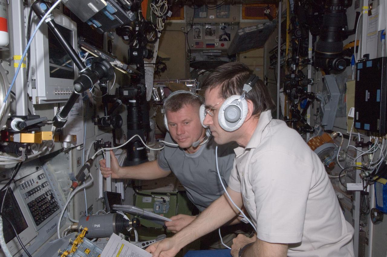 ISS033-E-017605 (31 Oct. 2012) --- Russian cosmonauts Yuri Malenchenko (foreground) and Oleg Novitskiy, both Expedition 33 flight engineers, monitor data at the manual TORU docking system controls in the Zvezda Service Module of the International Space Station during approach and docking operations of the unpiloted ISS Progress 49 resupply vehicle. Progress 49 docked automatically to Zvezda’s aft port at 9:33 a.m. (EDT) on Oct. 31, 2012.