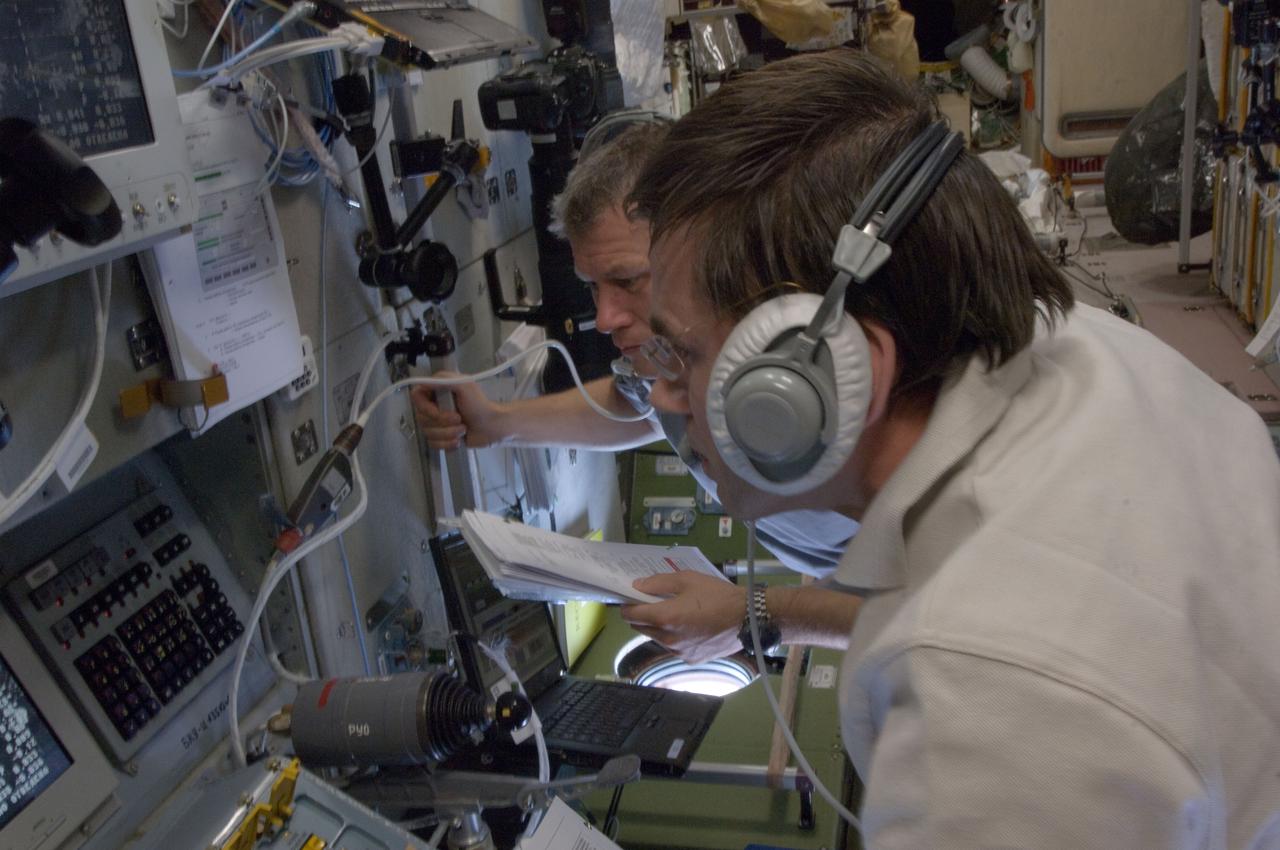 ISS033-E-017632 (31 Oct. 2012) --- Russian cosmonauts Yuri Malenchenko (foreground) and Oleg Novitskiy, both Expedition 33 flight engineers, monitor data at the manual TORU docking system controls in the Zvezda Service Module of the International Space Station during approach and docking operations of the unpiloted ISS Progress 49 resupply vehicle. Progress 49 docked automatically to Zvezda’s aft port at 9:33 a.m. (EDT) on Oct. 31, 2012.