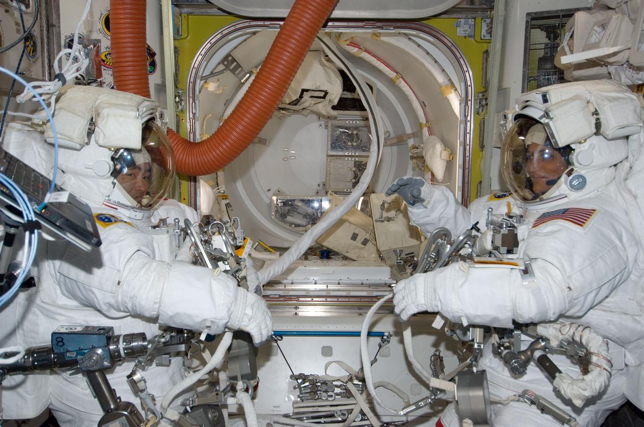 ISS033-E-018378 (1 Nov. 2012) --- NASA astronaut Sunita Williams (right), Expedition 33 commander; and Japan Aerospace Exploration Agency astronaut Aki Hoshide, flight engineer, are pictured in the Quest airlock of the International Space Station as they prepare for the start of a session of extravehicular activity (EVA) outside the International Space Station on Nov. 1, 2012. Williams and Hoshide are wearing Extravehicular Mobility Unit (EMU) spacesuits.