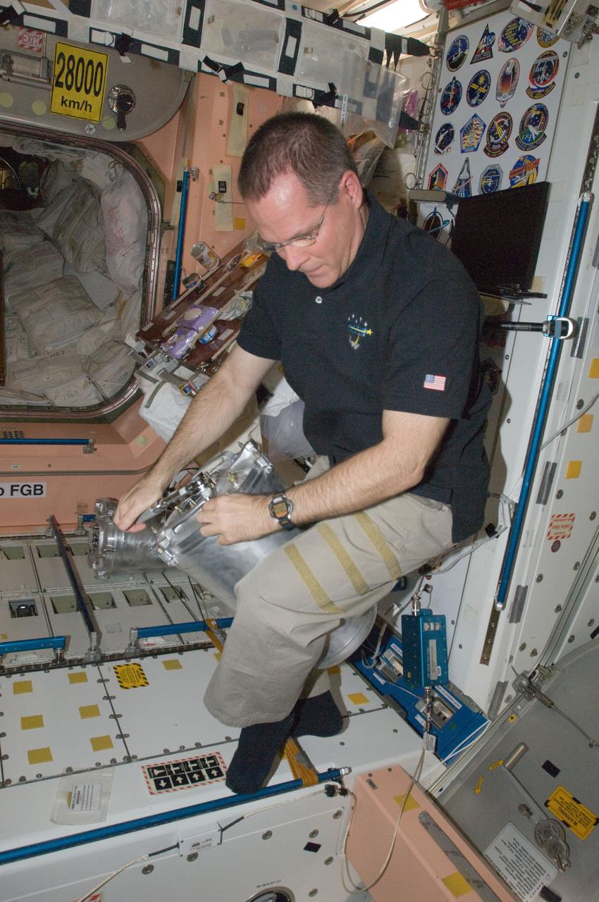 ISS033-E-018790 (6 Nov. 2012) --- NASA astronaut Kevin Ford, Expedition 33 flight engineer, performs in-flight maintenance on the Waste and Hygiene Compartment (WHC) toilet facilities in the Unity node of the International Space Station.