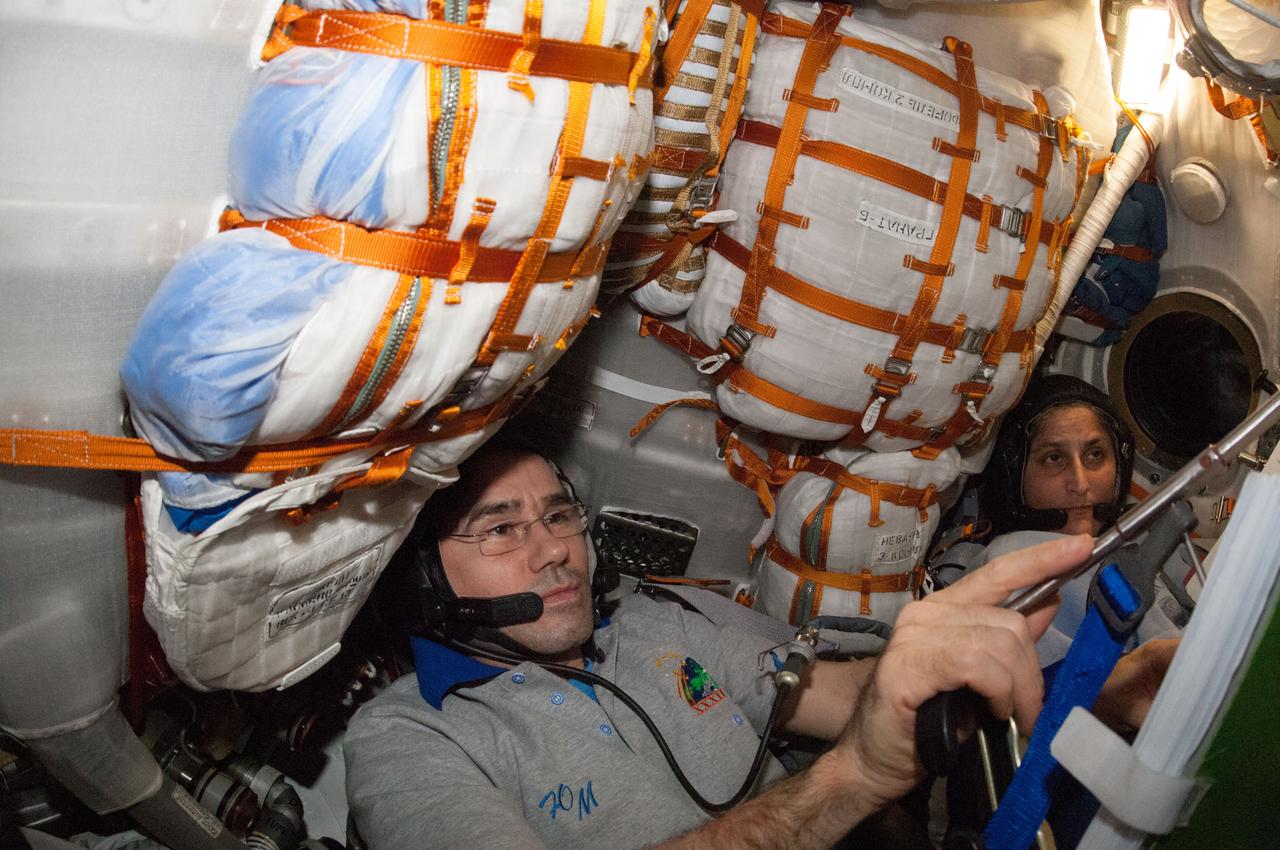 ISS033-E-021656 (16 Nov. 2012) --- Russian cosmonaut Yuri Malenchenko (left), Soyuz commander and Expedition 33 flight engineer; NASA astronaut Sunita Williams, Expedition 33 commander; and Japan Aerospace Exploration Agency astronaut Aki Hoshide (out of frame), flight engineer, participate in a standard training exercise in the Soyuz TMA-05M spacecraft in preparation for their return to Earth scheduled for Nov. 18, 2012 (U.S. time).