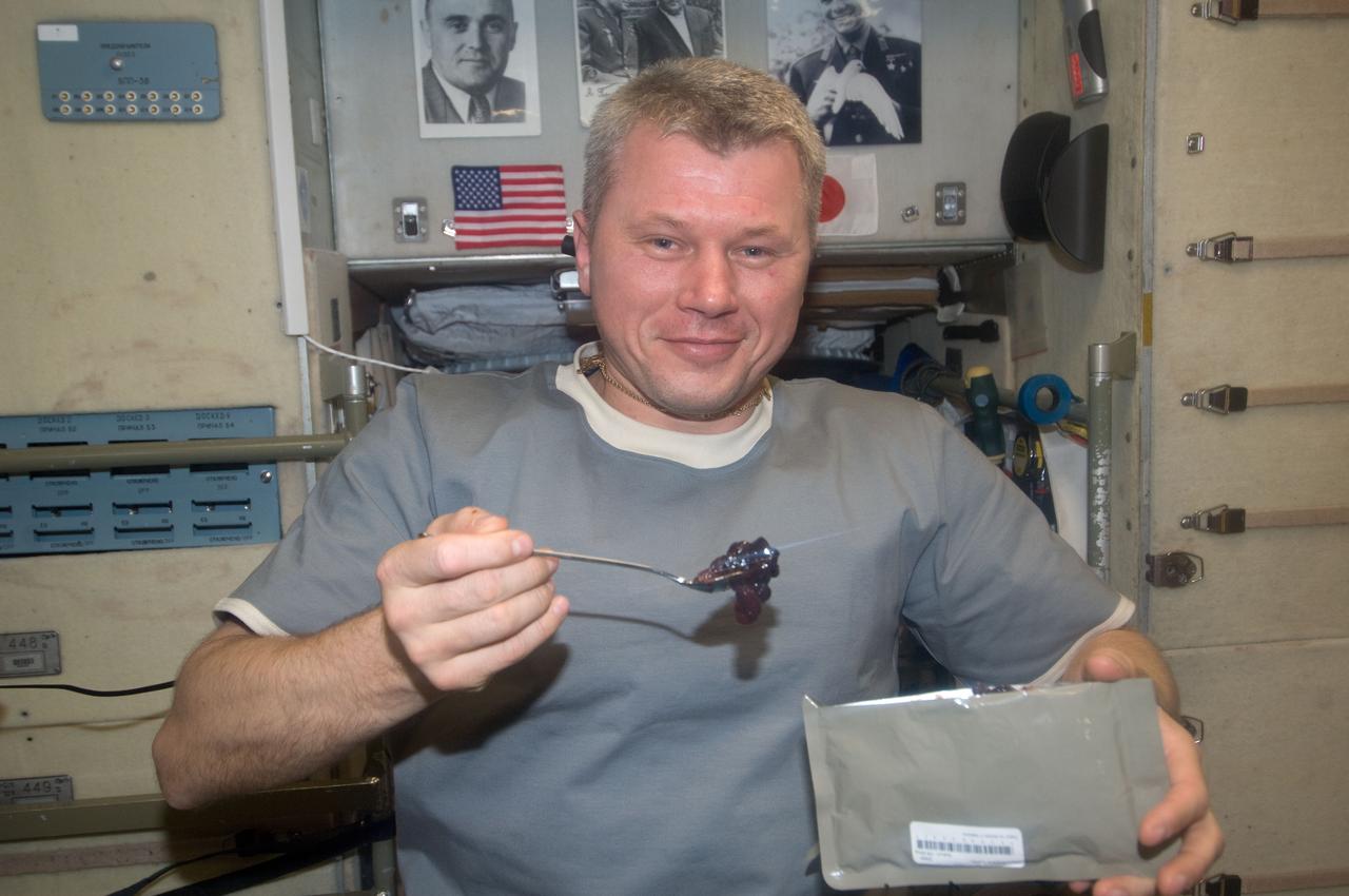 ISS034-E-005218 (21 Nov. 2012) --- Russian cosmonaut Oleg Novitskiy, Expedition 34 flight engineer, eats a snack near the galley in the Zvezda Service Module of the International Space Station.