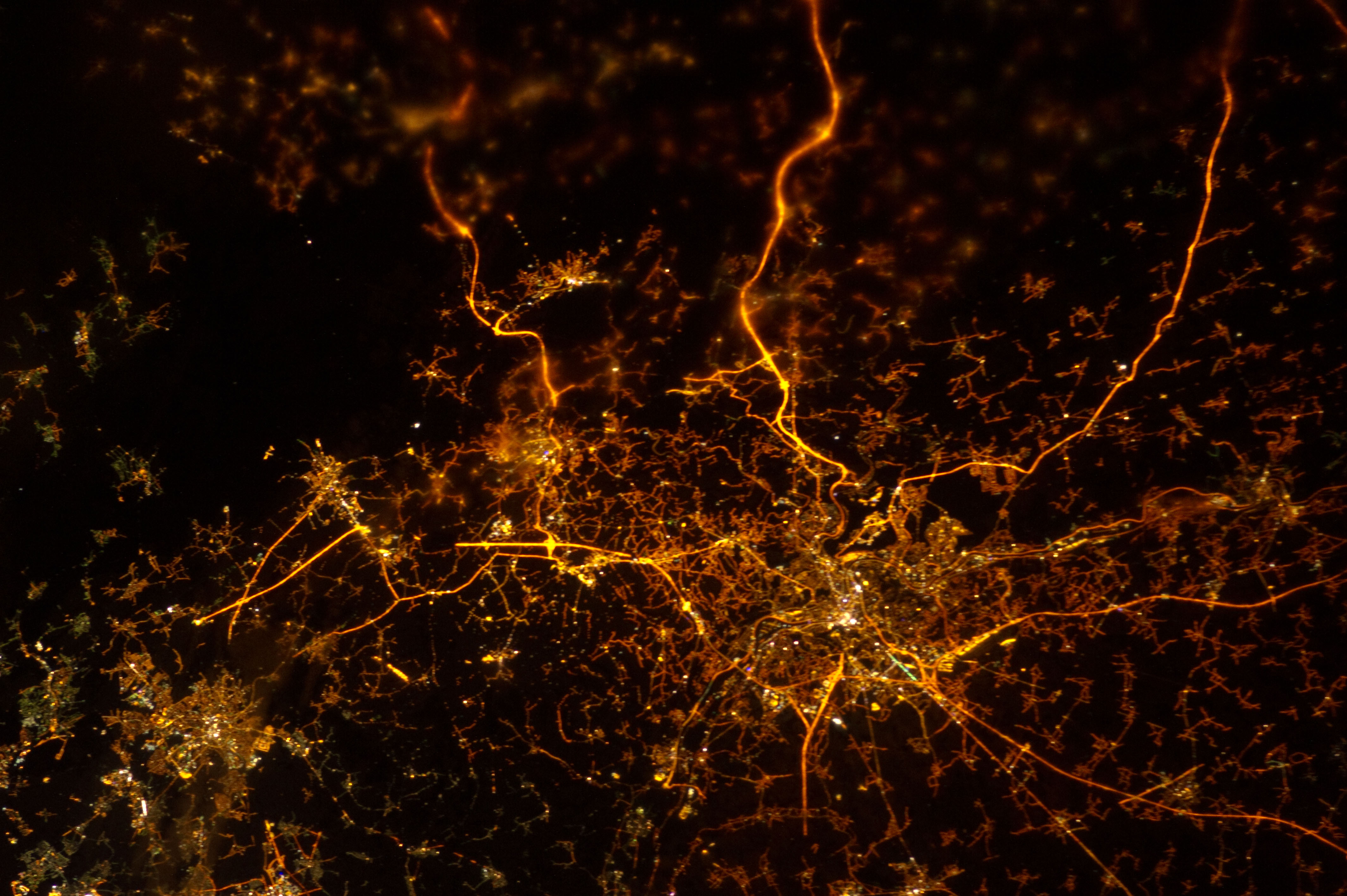 ISS034-E-005935 (8 Dec. 2012) --- A nighttime view of Liege, Belgium is featured in this image photographed by an Expedition 34 crew member on the International Space Station. To paraphrase the old expression, “all roads lead to Liege” – or at least one could get that impression from this nighttime photograph. The brightly lit core of the Liege urban area appears to lie at the center of a network of roadways—traceable by continuous orange lighting—extending outwards into the rural, and relatively dark, Belgium countryside. For a sense of scale the distance from left to right is approximately 70 kilometers. The region at upper left to the southeast of Verviers includes agricultural fields and forest; hence it appears almost uniformly dark at night. The image was taken using the European Space Agency’s Nodding mechanism, also known as the NightPod. NightPod is an electro-mechanical mount system designed to compensate digital cameras for the motion of the space station relative to Earth. The primary mission goal was to take high-resolution, long exposure digital imagery of Earth from the station’s Cupola, particularly cities at night. While the official NightPod mission has been completed, the mechanism remains onboard for crew members to use. Liege is the third most populous metropolitan region in Belgium (after Brussels and Antwerp); it includes 52 municipalities, including the nearby city of Seraing.