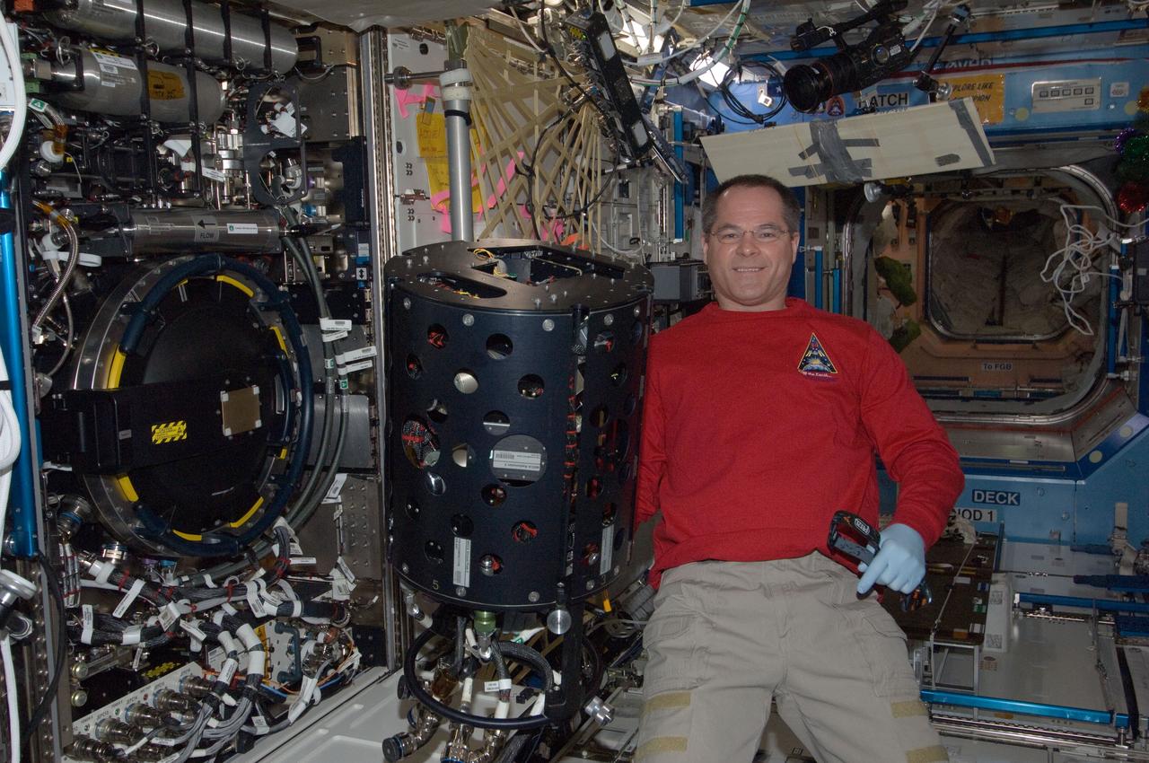 ISS034-E-007409 (12 Dec. 2012) --- NASA astronaut Kevin Ford, Expedition 34 commander, performs in-flight maintenance on the Combustion Integrated Rack (CIR) Multi-user Droplet Combustion Apparatus (MDCA) in the International Space Station’s Destiny laboratory.