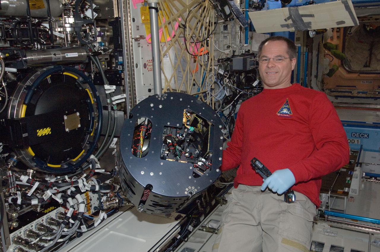 ISS034-E-007411 (12 Dec. 2012) --- NASA astronaut Kevin Ford, Expedition 34 commander, performs in-flight maintenance on the Combustion Integrated Rack (CIR) Multi-user Droplet Combustion Apparatus (MDCA) in the International Space Station’s Destiny laboratory.