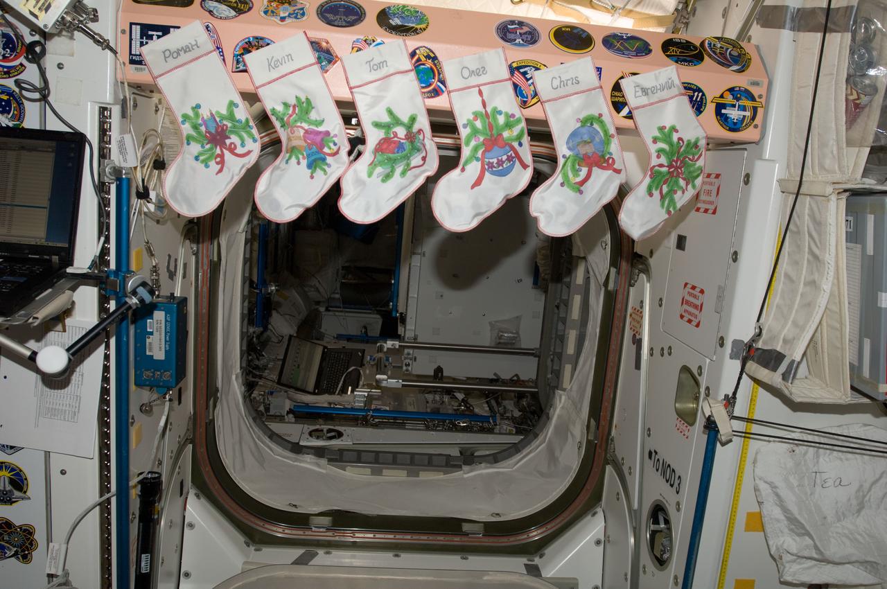 View of Expedition 34 Christmas stockings hanging at the Node 1 hatch. Photo was taken during Expedition 34.