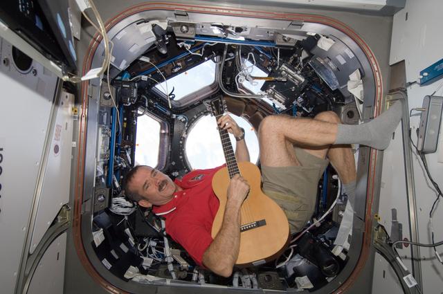 NASA image: Hadfield plays guitar in the Cupola Module