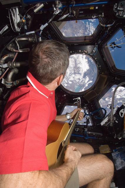 Hadfield plays guitar in the Cupola Module