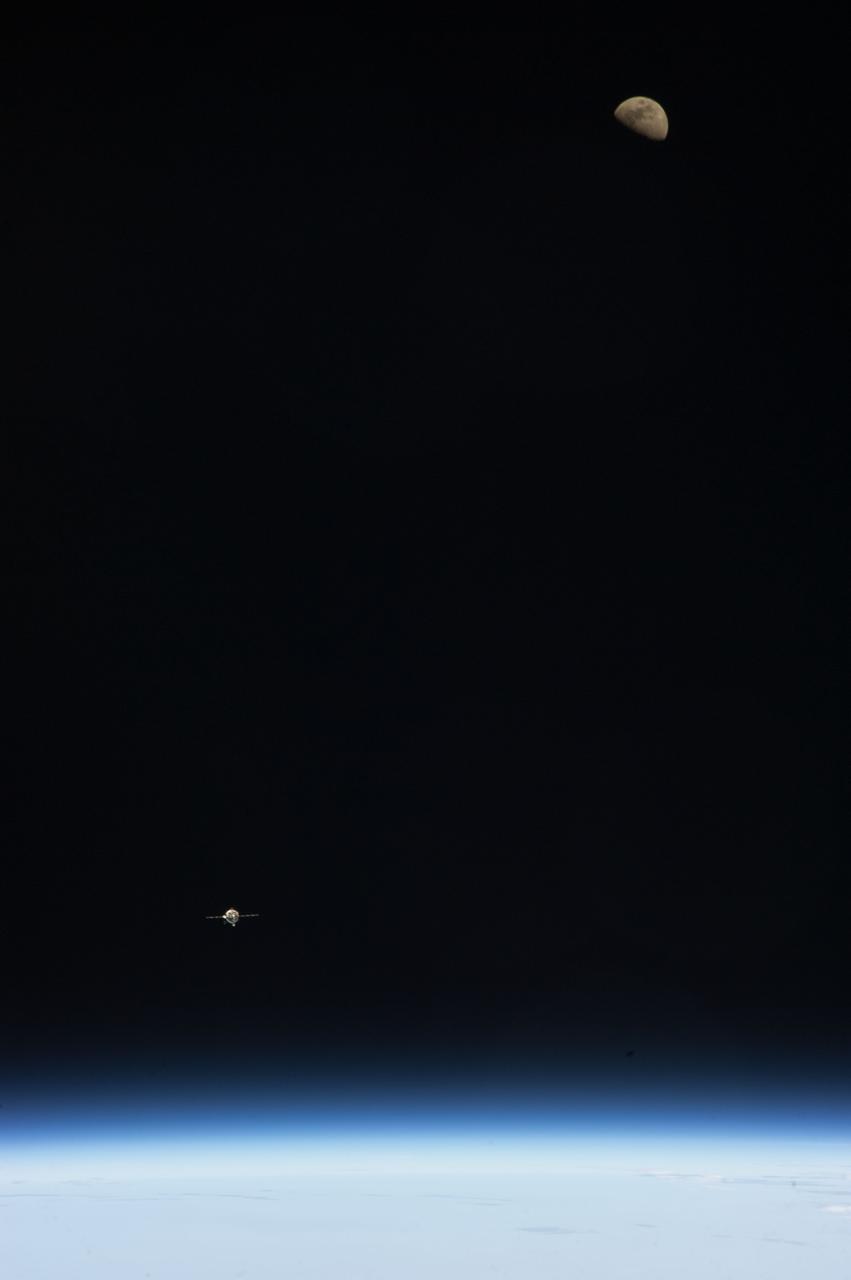 ISS034-E-009895 (21 Dec. 2012) --- As the International Space Station and Soyuz  TMA-07M spacecraft were making their relative approaches on Dec. 21, one of the Expedition 34 crew members on the orbital outpost captured this photo of the Soyuz (lower left) and a gibbous moon (upper right). Inside the approaching spacecraft were astronaut Chris Hadfield of the Canadian Space Agency, cosmonaut Roman Romanenko of Russia's Federal Space Agency and NASA astronaut Tom Marshburn.