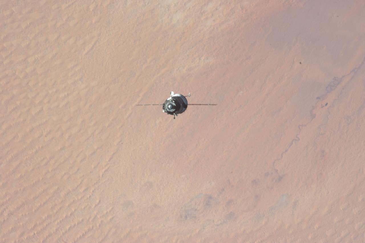 ISS034-E-009926 (21 Dec. 2012) --- As the International Space Station and Soyuz  TMA-07M spacecraft were making their relative approaches on Dec. 21, one of the Expedition 34 crew members on the orbital outpost captured this photo of the Soyuz over the Sahara Desert. The image center is at 31.7 degrees north latitude and  2.0 degrees east longitude, on the south side of the Atlas Mountains and on the northern margin of a huge dune field known as Grand Erg Occidental, located in north central Algeria. Inside the arriving spacecraft were astronaut Chris Hadfield of the Canadian Space Agency, cosmonaut Roman Romanenko of Russia's Federal Space Agency and NASA astronaut Tom Marshburn.