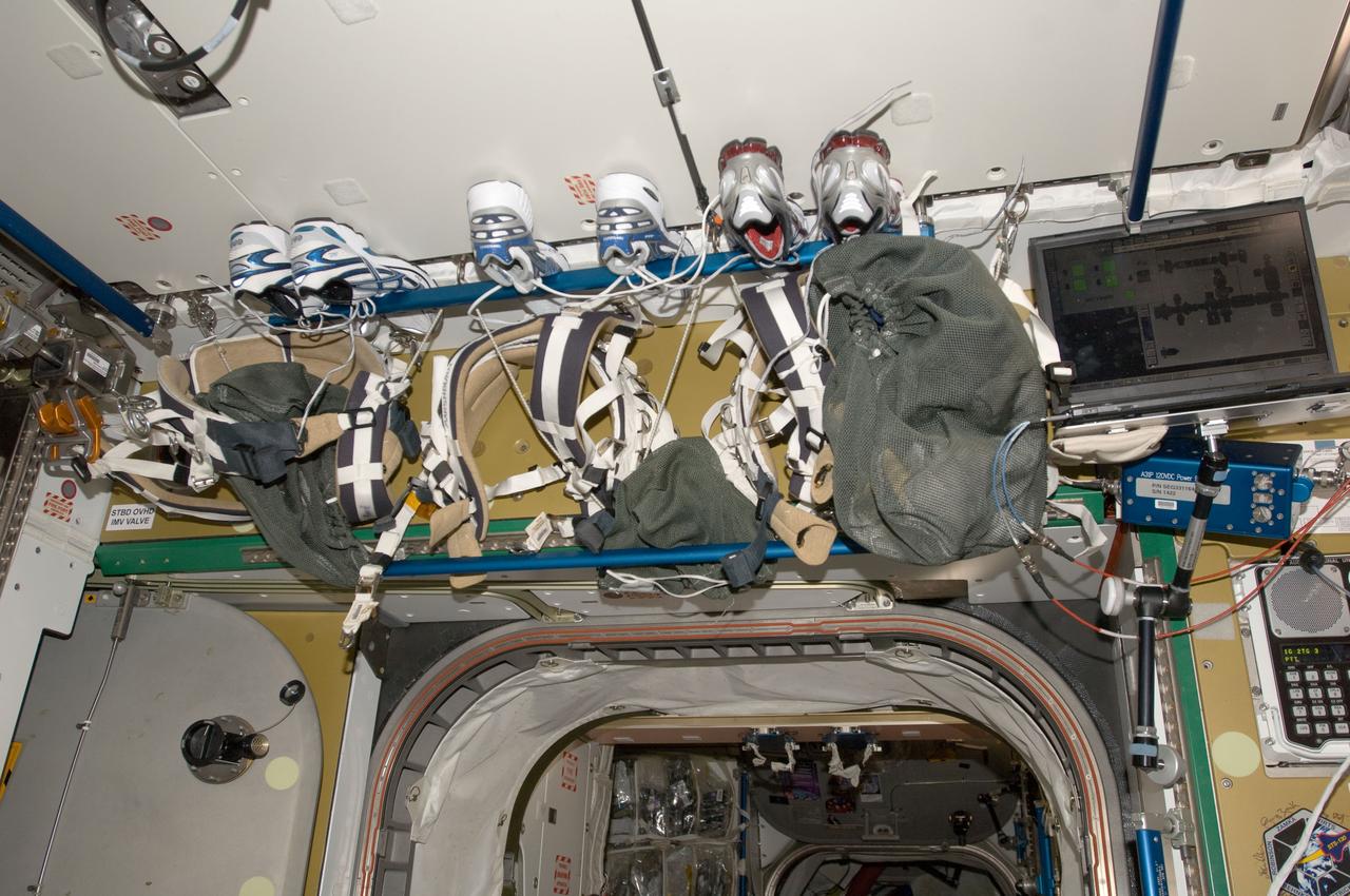 View of Avionics Rack 2 Closeout Panel with tennis shoes,in the Node 3. Photo was taken during Expedition 34.