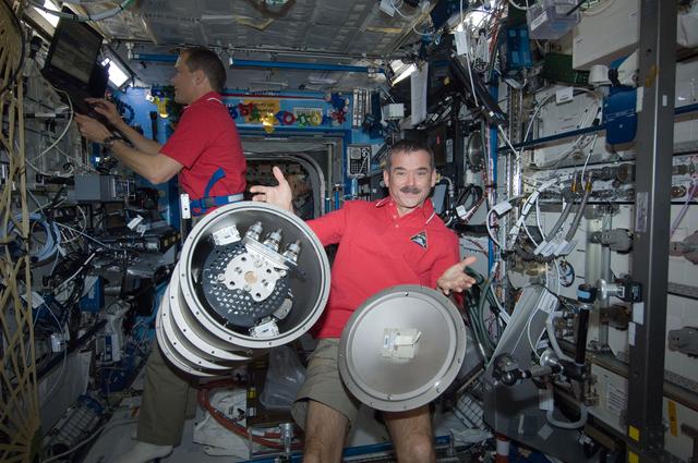NASA image: Hadfield poses with MSL FLSS in the Node 2