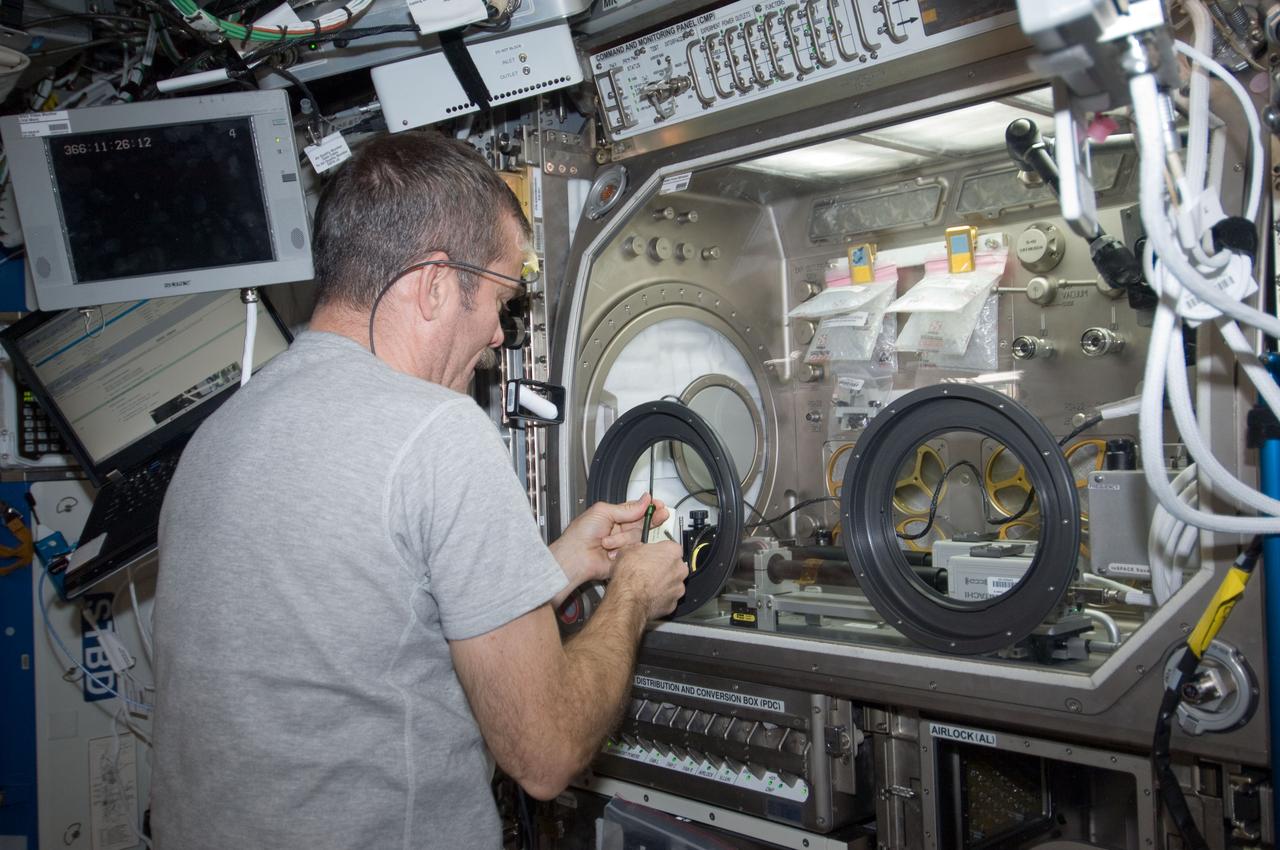 ISS034-E-010631 (31 Dec. 2012) --- Canadian Space Agency astronaut Chris Hadfield, Expedition 34 flight engineer, works with the InSpace-3 investigation in the Microgravity Science Glovebox (MSG) in the Destiny laboratory of the International Space Station.